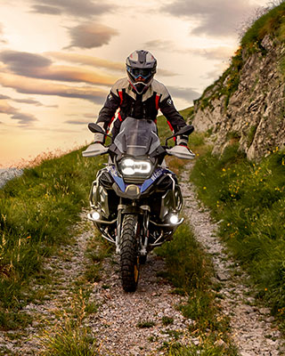 Riding scene with the BMW R 1250 GS Adventure in the mountains on unpaved road
